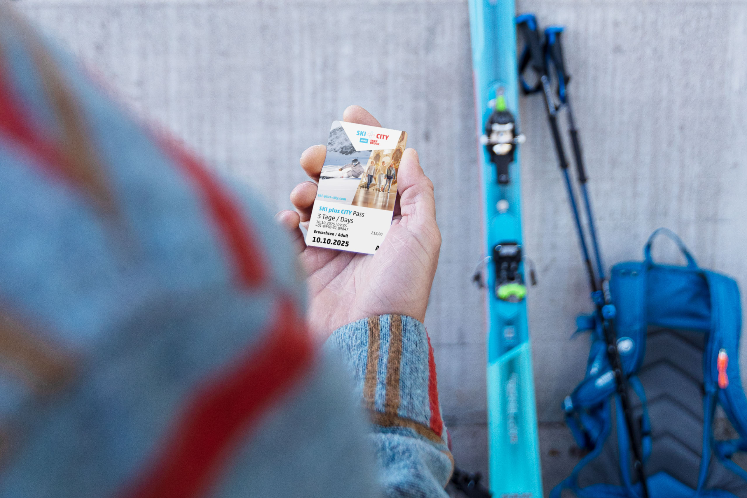 Someone holds the Ski & City Pass up to the camera