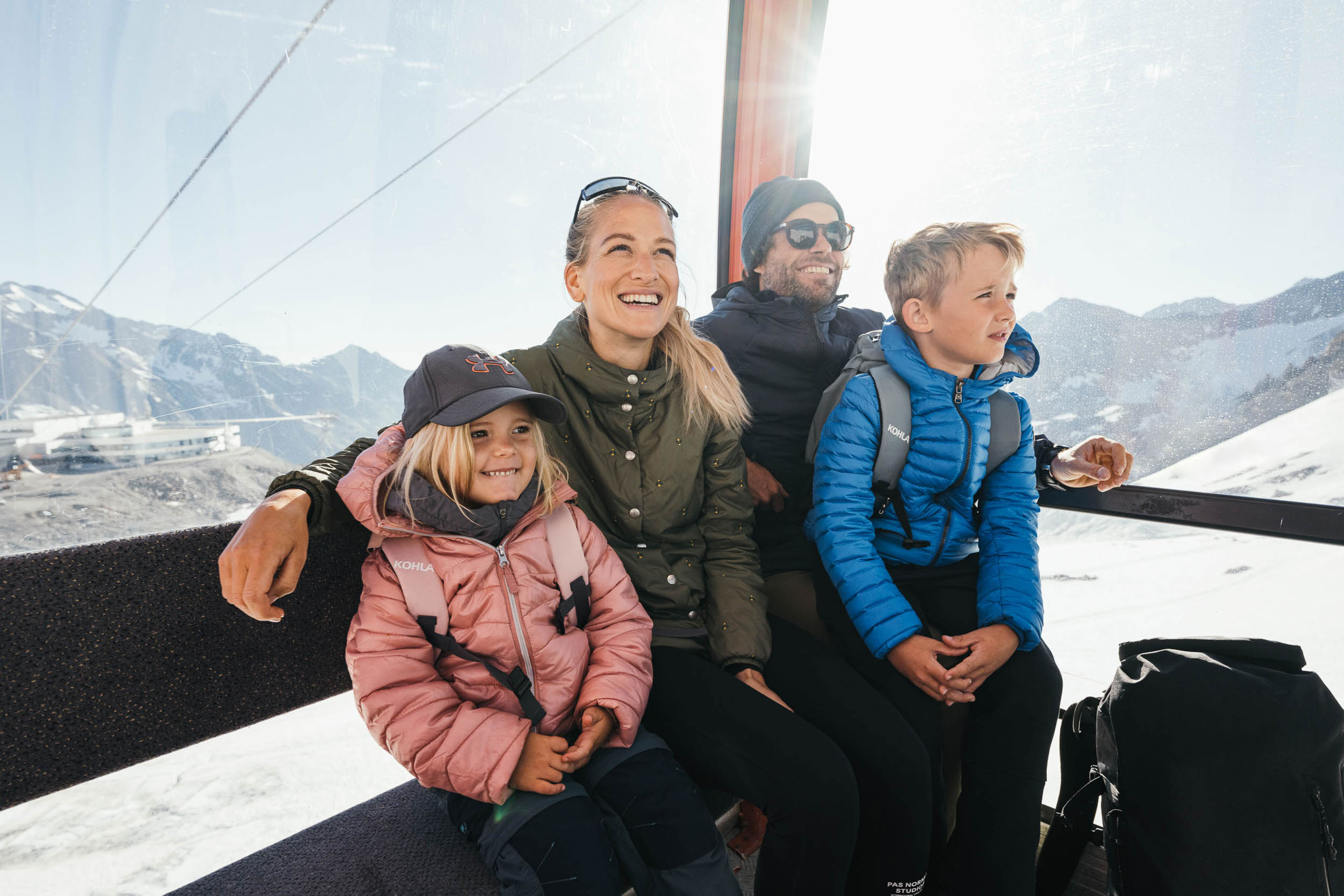 A happy family in a gondola at Stubai Glacier