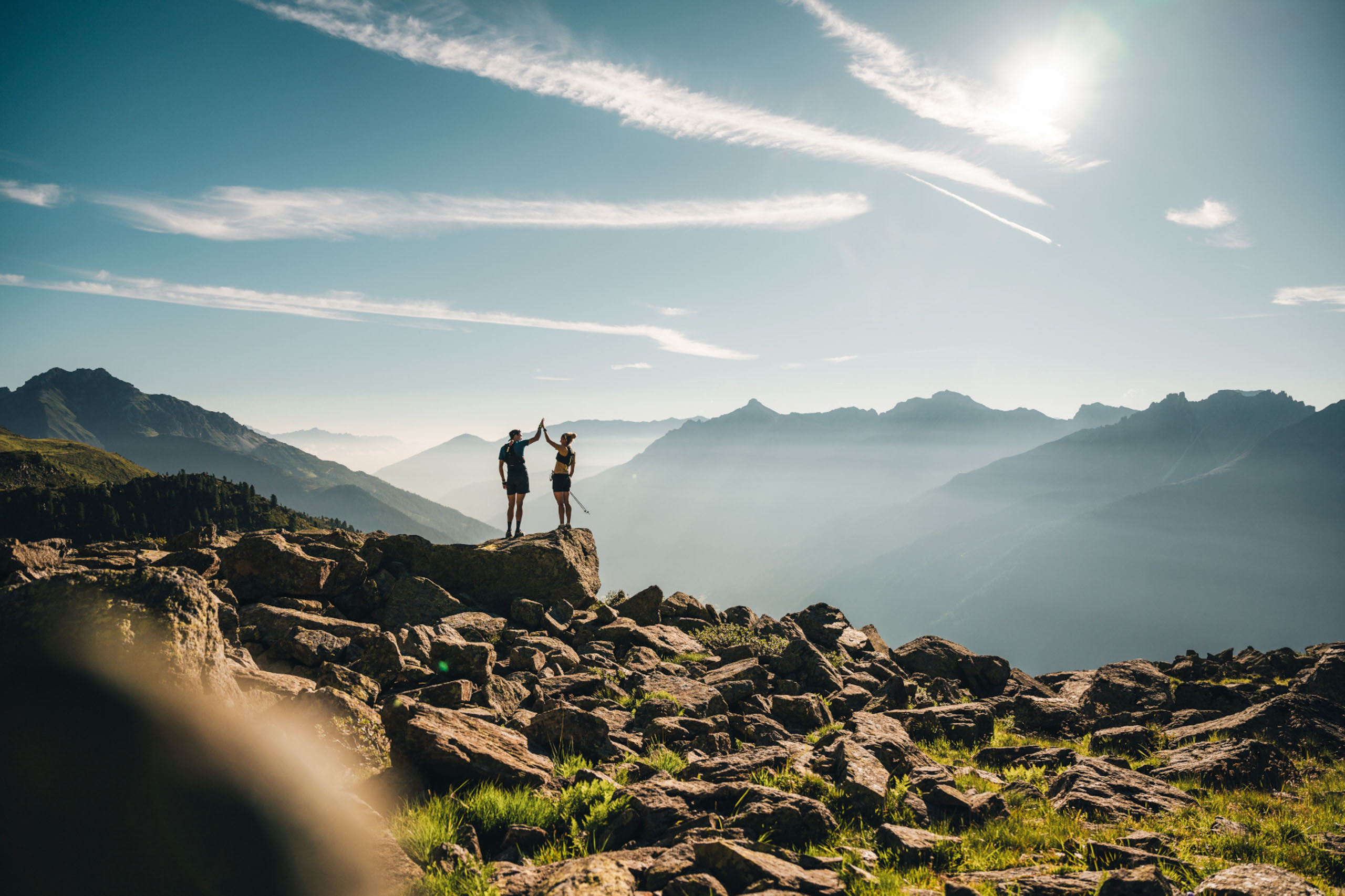 A man and a woman give each other a high five at the UltraTrail