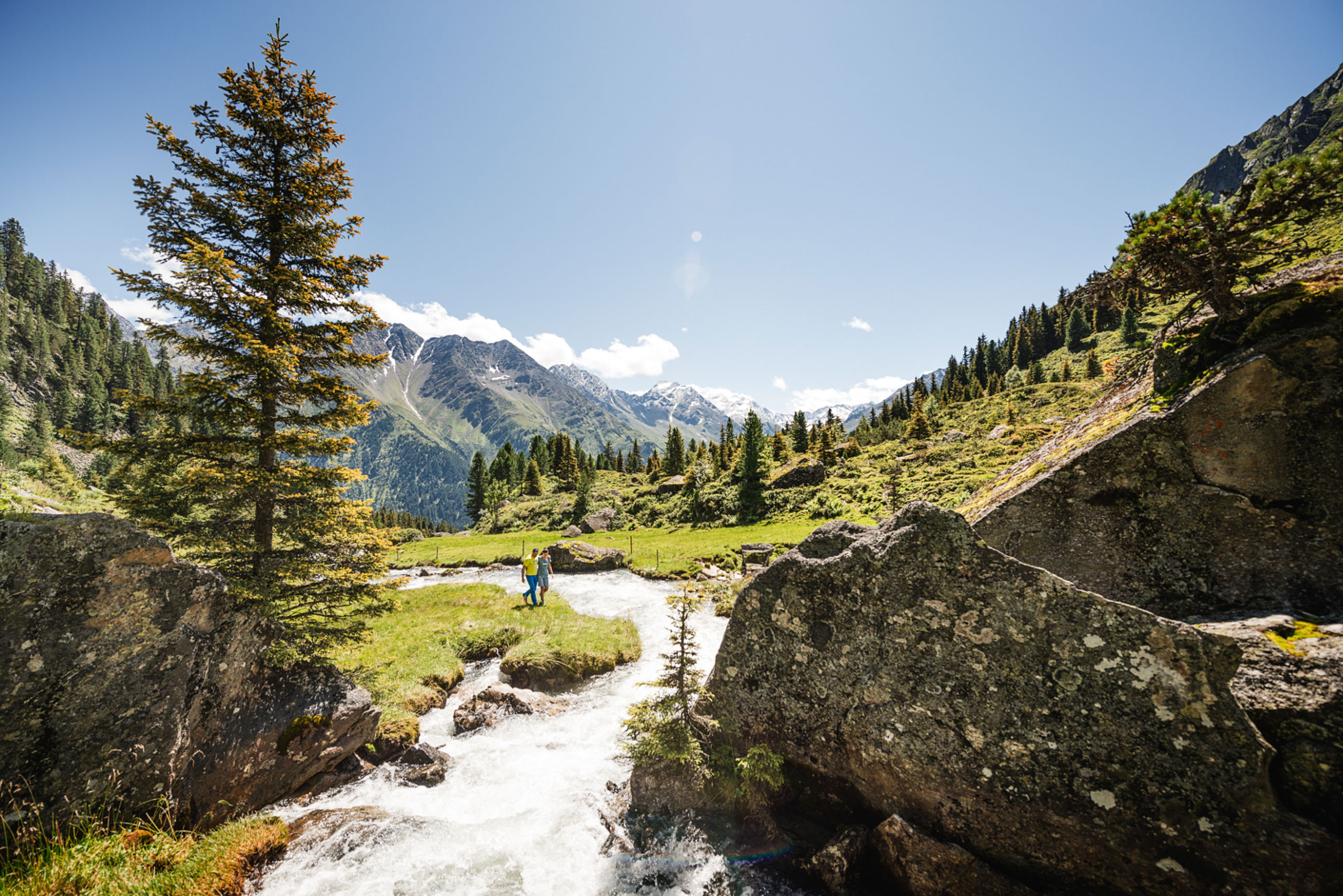 A couple hiking along the Ruetz in Stubai Valley